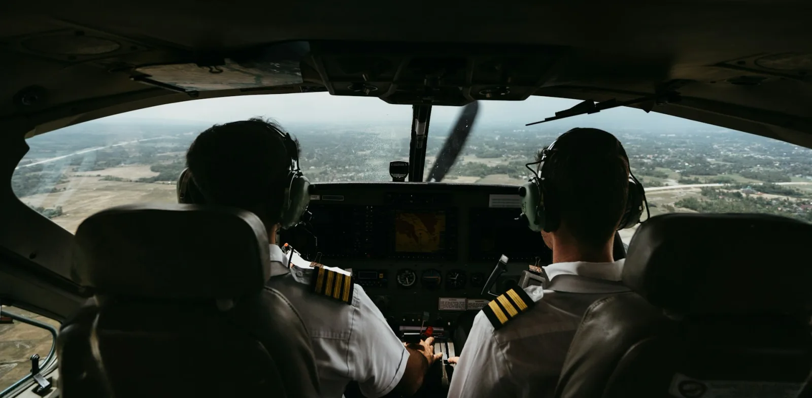 Two pilots in the cockpit of a NextGen training aircraft on a Southern California cross-country flight